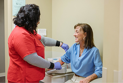 Nurse checking patients veins to draw blood for testing
