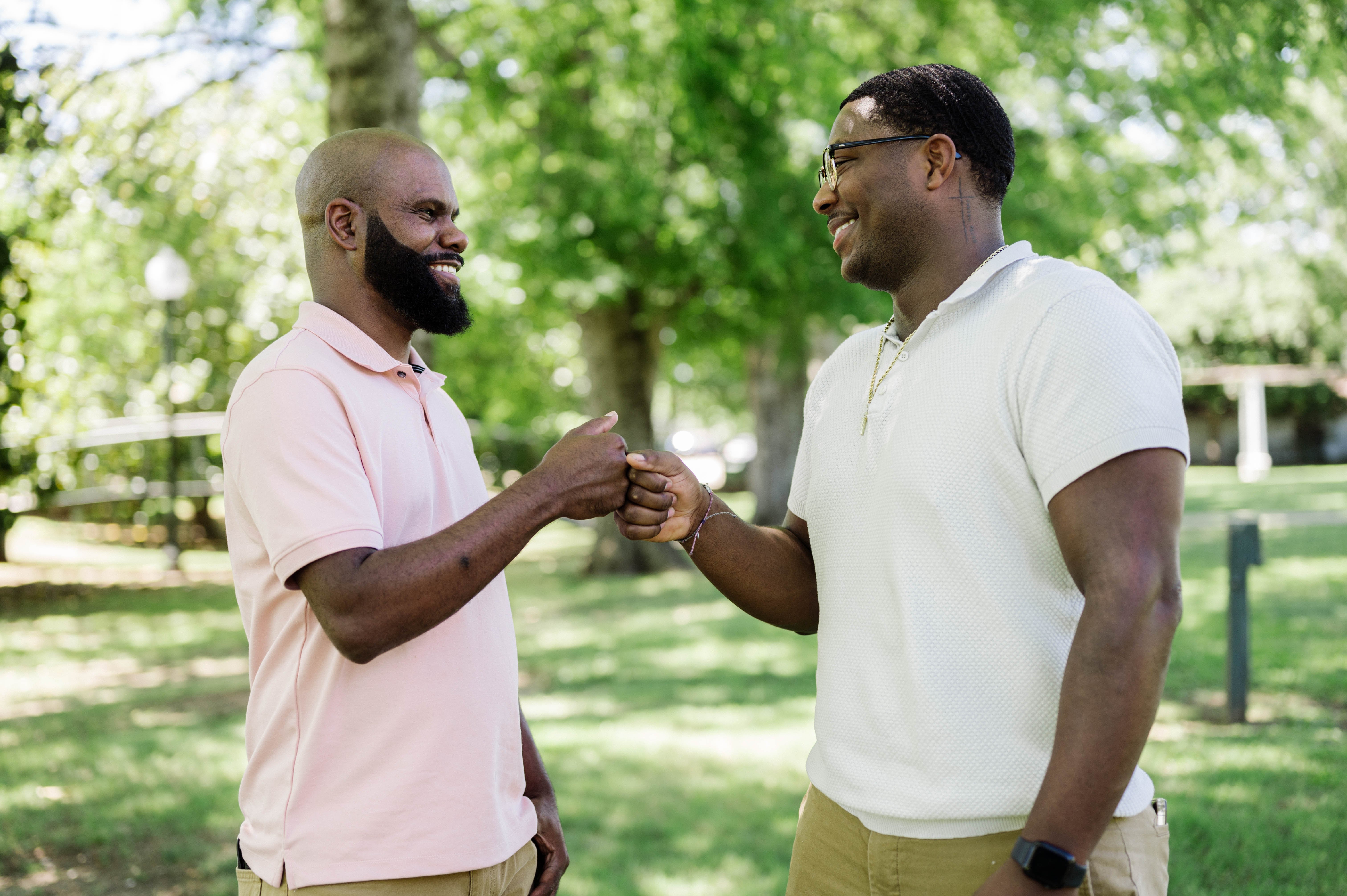 Two men fist bumping