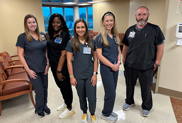 health care workers in scrubs standing in the lobby