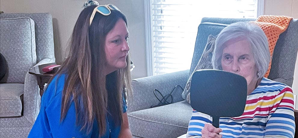 Home health team member works with patient