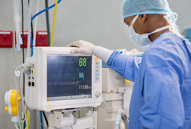 Health care provider looking at a monitor