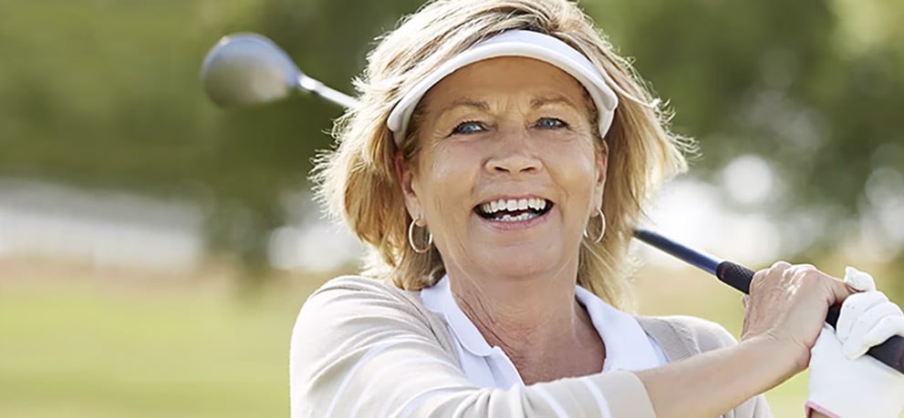 Middle aged woman playing golf