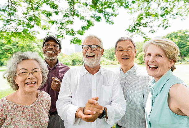 group of friends laughing in the park