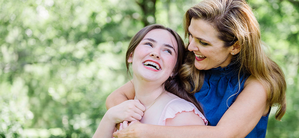 two women hugging and laughing