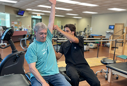 Physical Therapist working with patient with shoulder injury