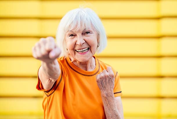 Older woman punching fist in exercise