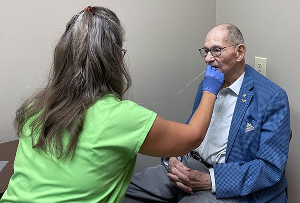 Speech therapist doing swallowing exercises with male patient