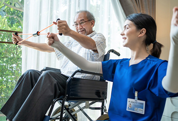 man in wheel chair doing physical therapy