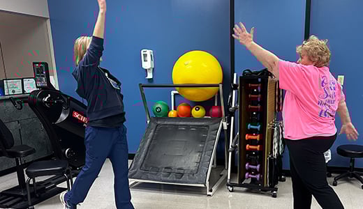 Therapist and patient work on mobility exercises