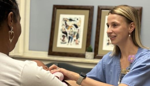 nurse counseling new mom about breastfeeding
