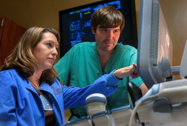 maternal fetal medicine specialist Dr. Brewer with tech reviewing a detailed ultrasound on monitor