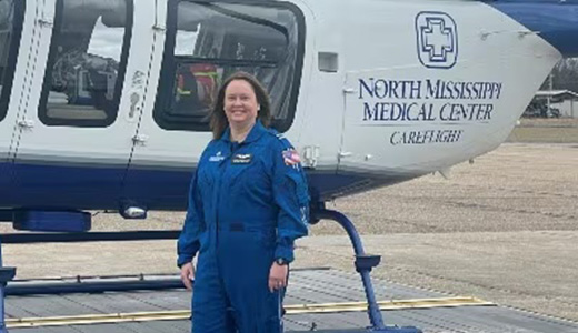 Cynthia Lentz in front of a helicopter