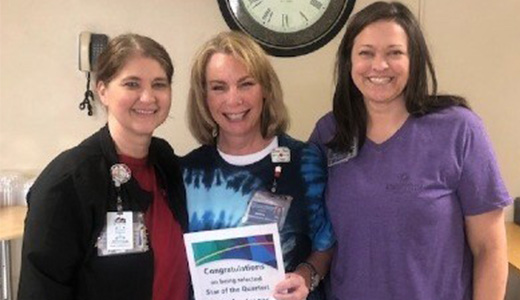 Dadra Lucas (center), RN, receives the Star of the Quarter award from April Franks (left), nursing supervisor, and Jennifer Brewer (right), chief nursing officer.