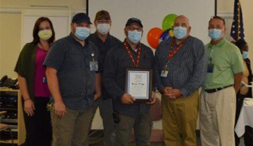 Barry Keel (right), administrator of NMMC-West Point, and Facility Operations teammates congratulate Keith White (center) upon being named as the hospital’s most recent Employee of the Quarter.