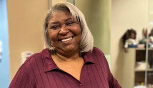 Dadra Lucas smiling in a red shirt