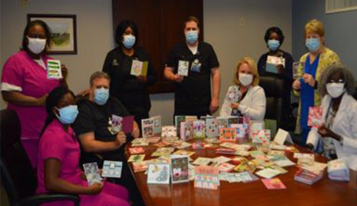 group picture around table full of thank you cards