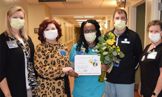 Caprina Bell being presented with the bee award