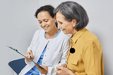 Smiling older woman meeting with health care provider