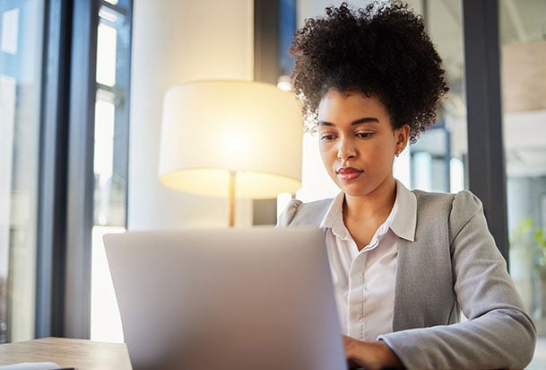 Woman typing on a laptop