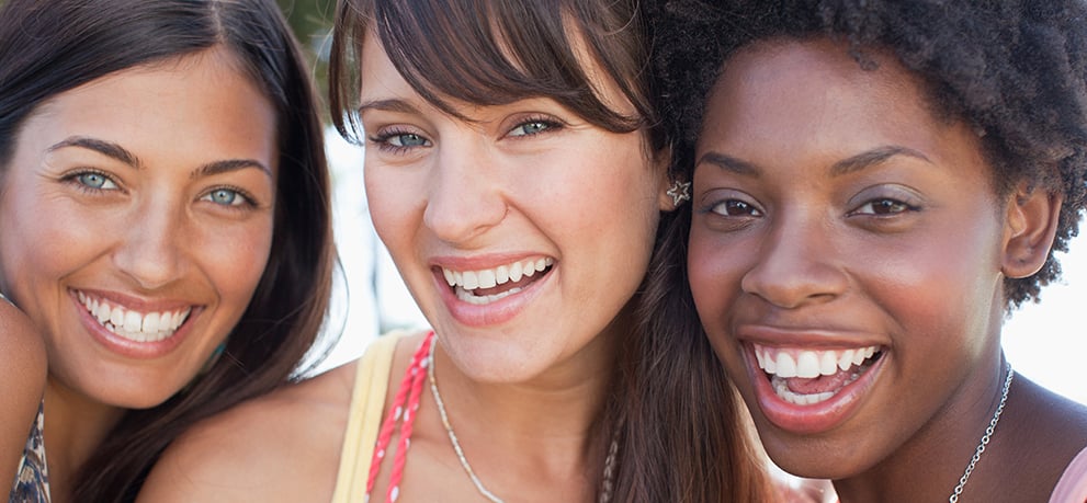 Three young women smiling
