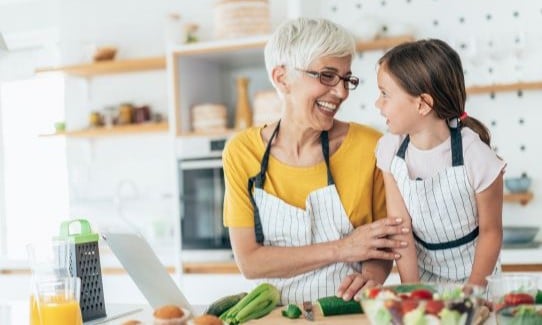Woman and young girl cooking together