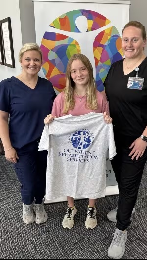 Karson with her physical therapy team
