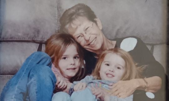 Lung cancer survivior Sherryl Jewett hugs two of her four grandchildren.