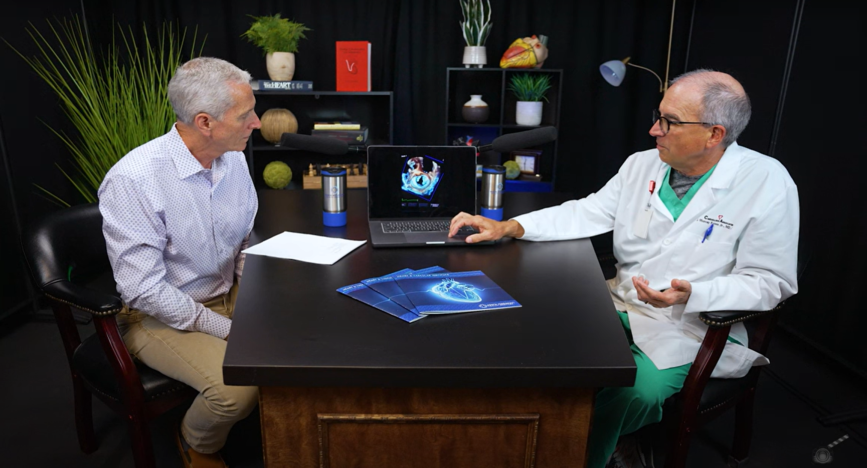 Dr. Bertolet and Estess discussing cardiac care with podcast microphones. 