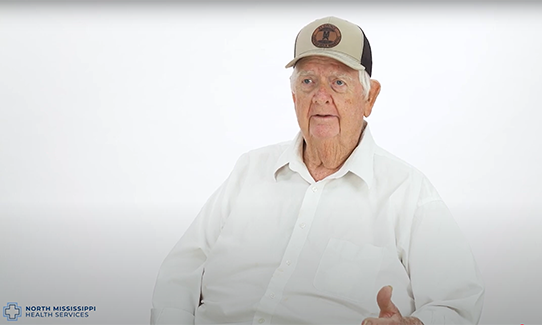 Bobby Burleson sitting in front of a white background, telling his story.