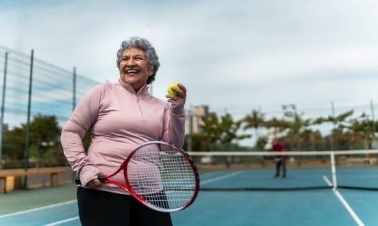 Woman in pink playing tennis