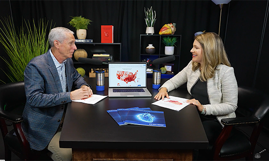 Dr. Bertolet and Morgan Roe talking on a podcast at a desk. 