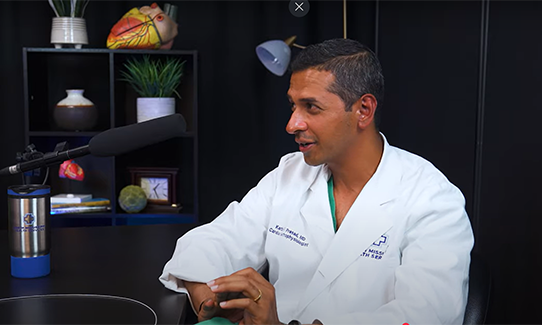 Dr. Prasad in a podcast studio. 
