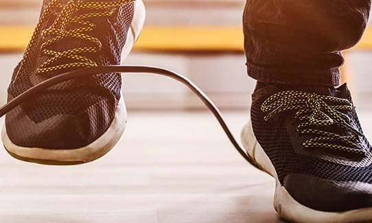 Close up of person's feet about to trip over a cord