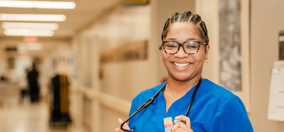 Smiling health care worker in hospital hallway