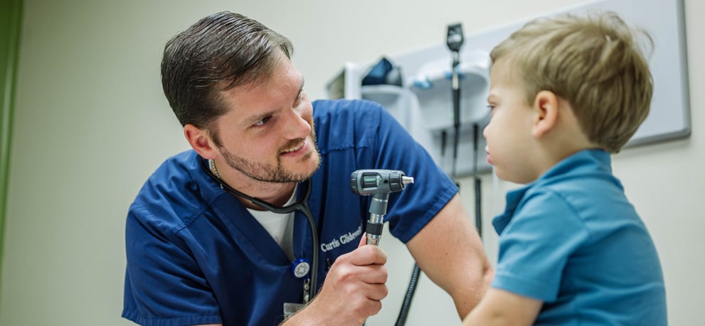 Dr. Curtis Glidewell examining a toddler patient