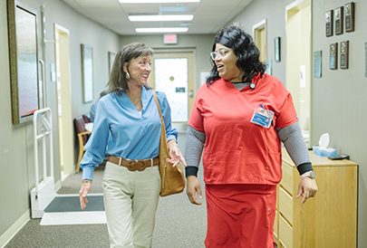 nurse in hospital walking with patient