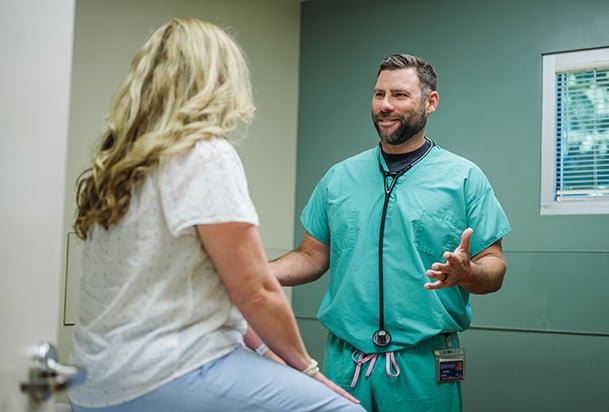 Doctor talking to female patient in an NMHS Urgent Care clinic
