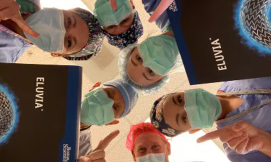 up angle of doctors holding eluvia wearing masks and hair nets