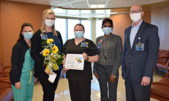 stacey being presented with the bee award