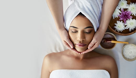 Woman lying on table receiving spa treatment