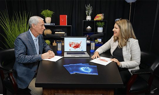 Dr. Bertolet and Morgan Roe talking on a podcast at a desk.
