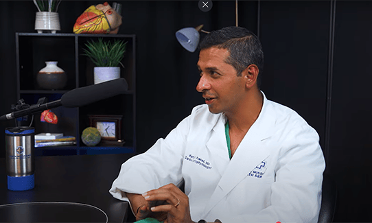 Dr. Prasad in a podcast studio.