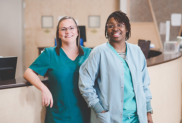 health care workers leaning on the front desk