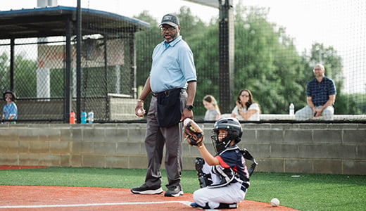 Little league baseball umpire and catcher