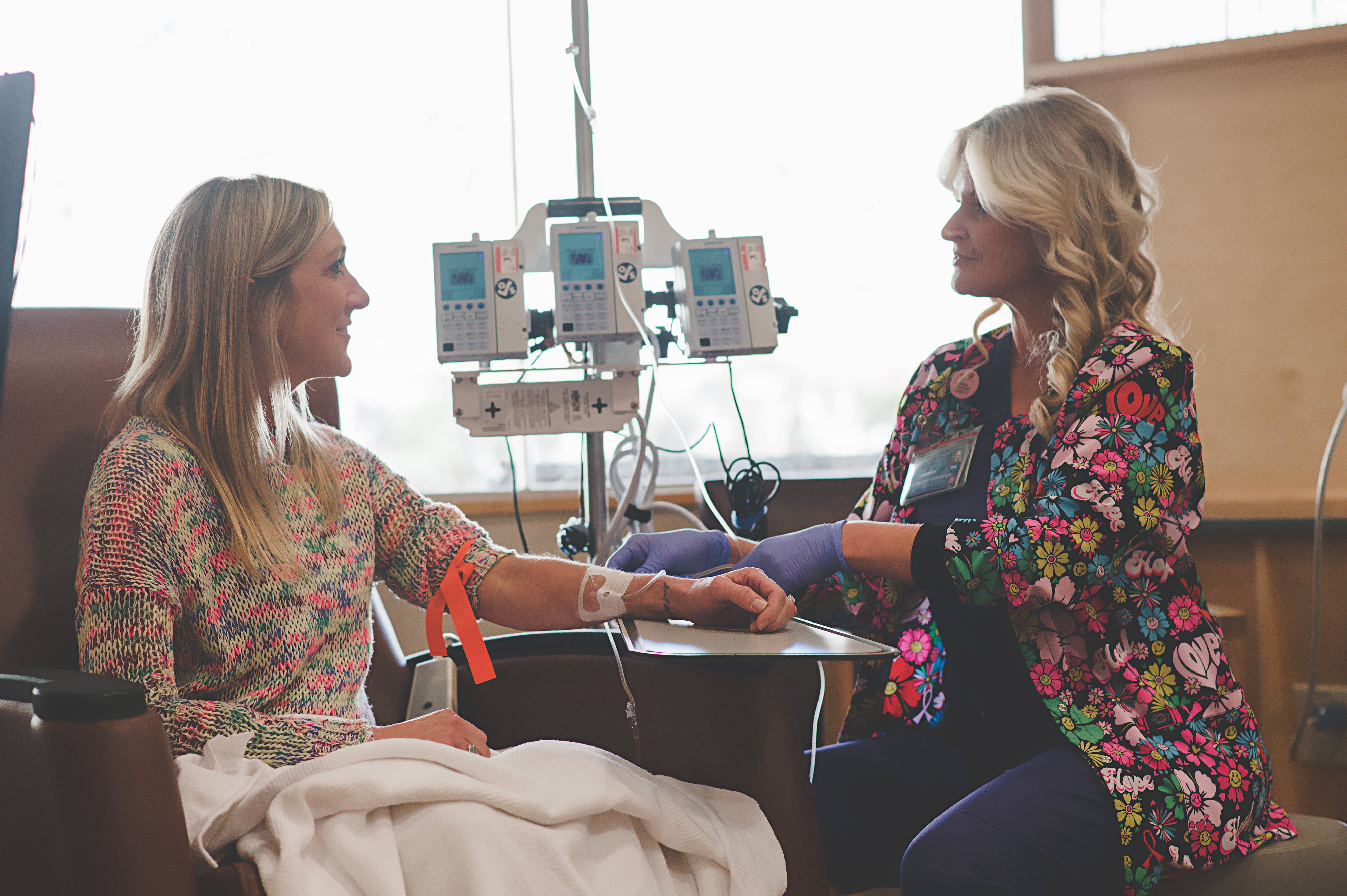 woman receiving chemotherapy from a health care worker