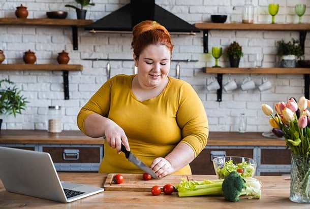 Woman chopping vegetables in kitchen