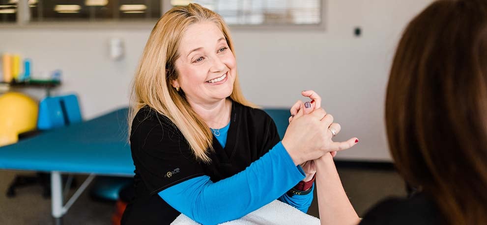 Therapist working with patient's hand