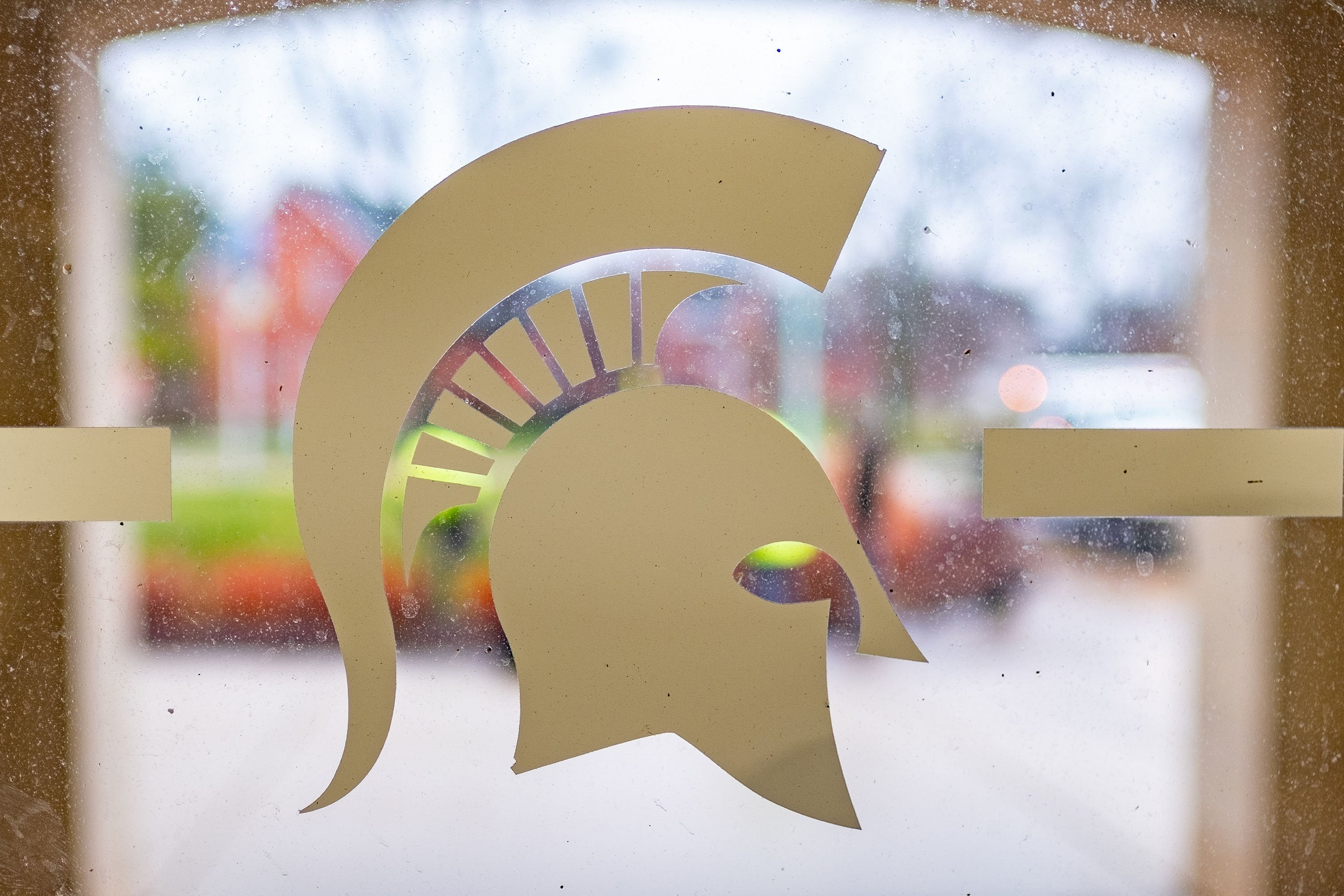 Spartan helmet decal on glass window looking out on West Circle Drive