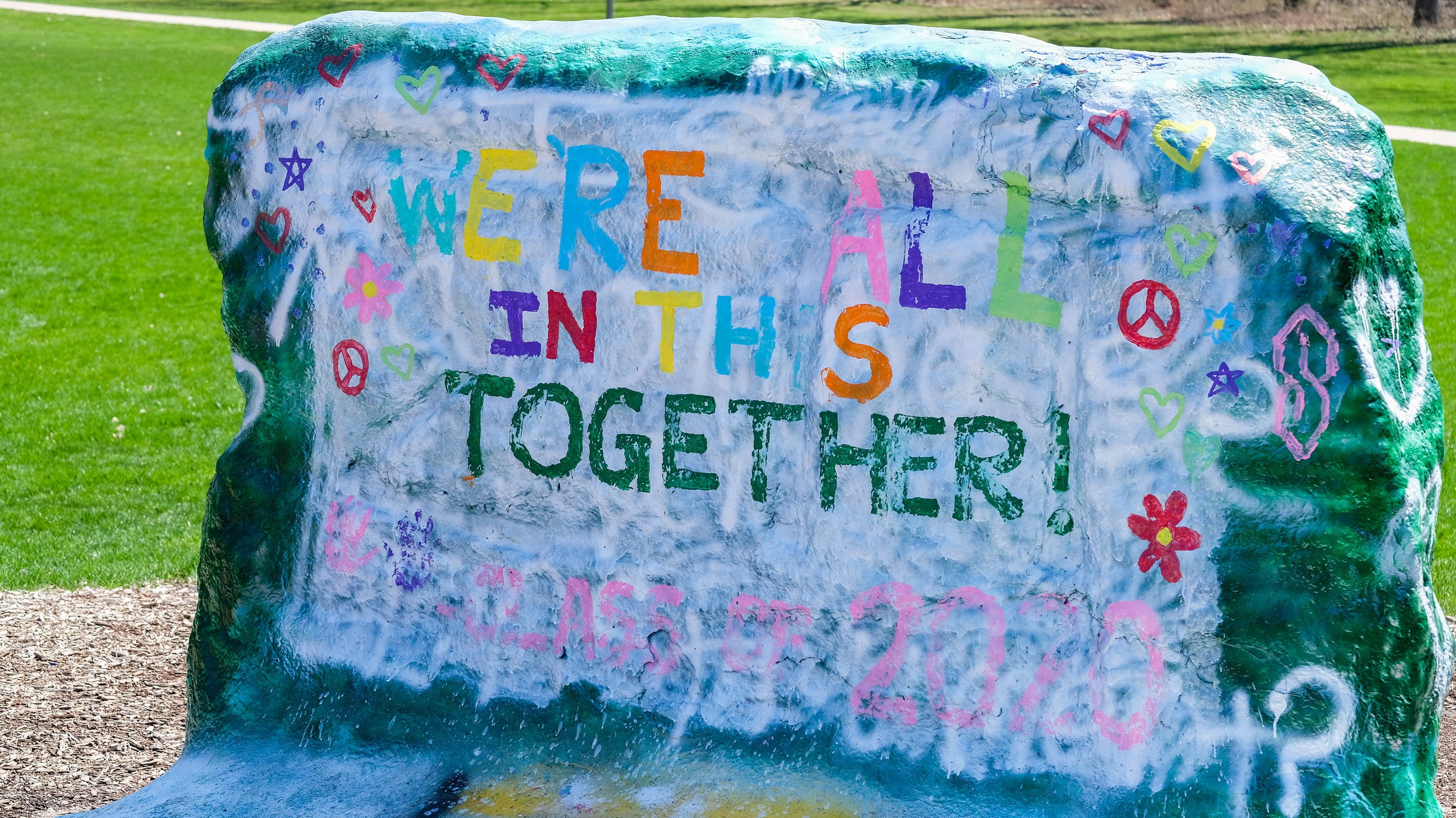 The rock, painted with the words 'we're all in this together'