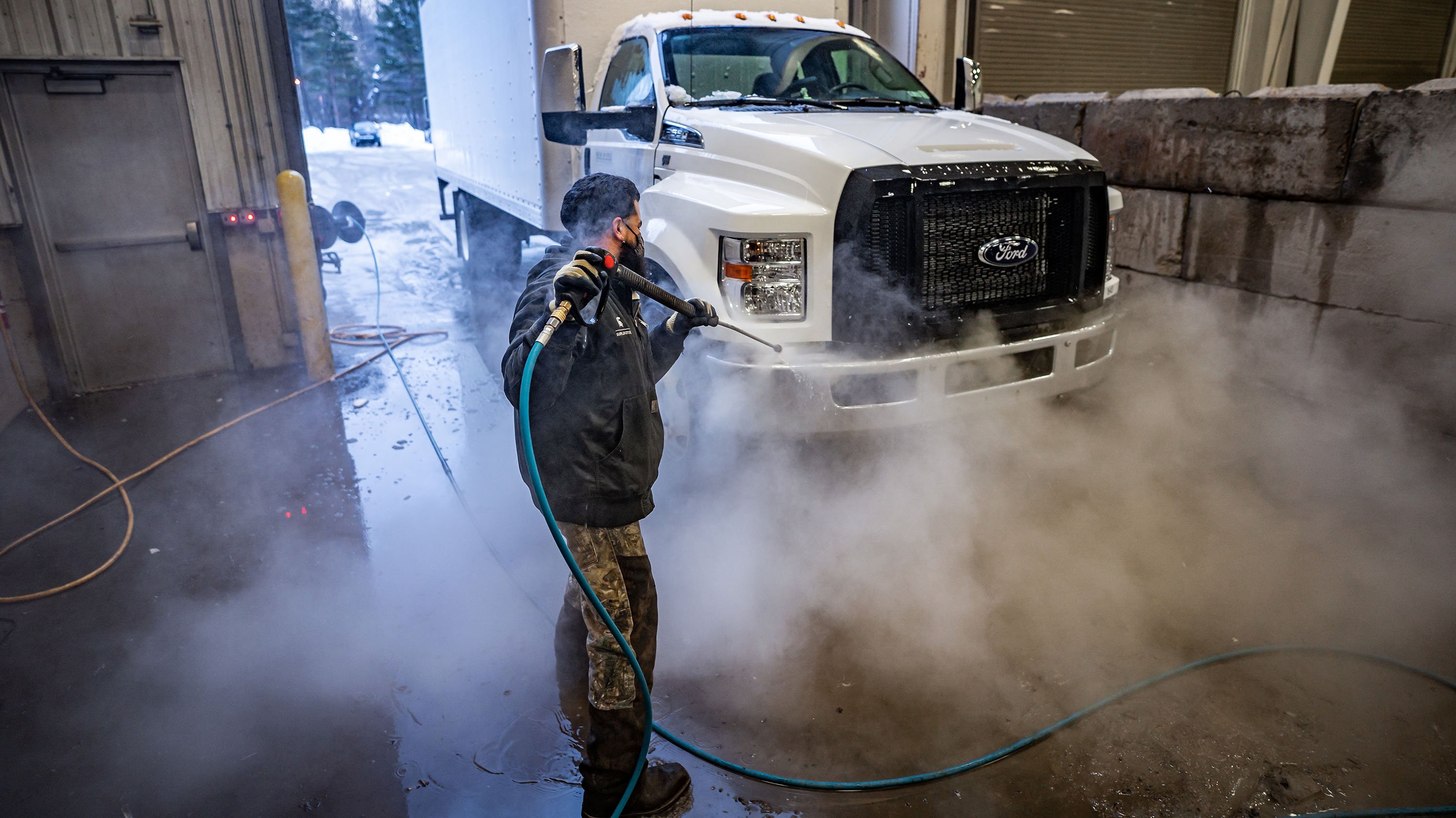 An IPF employee cleans a truck